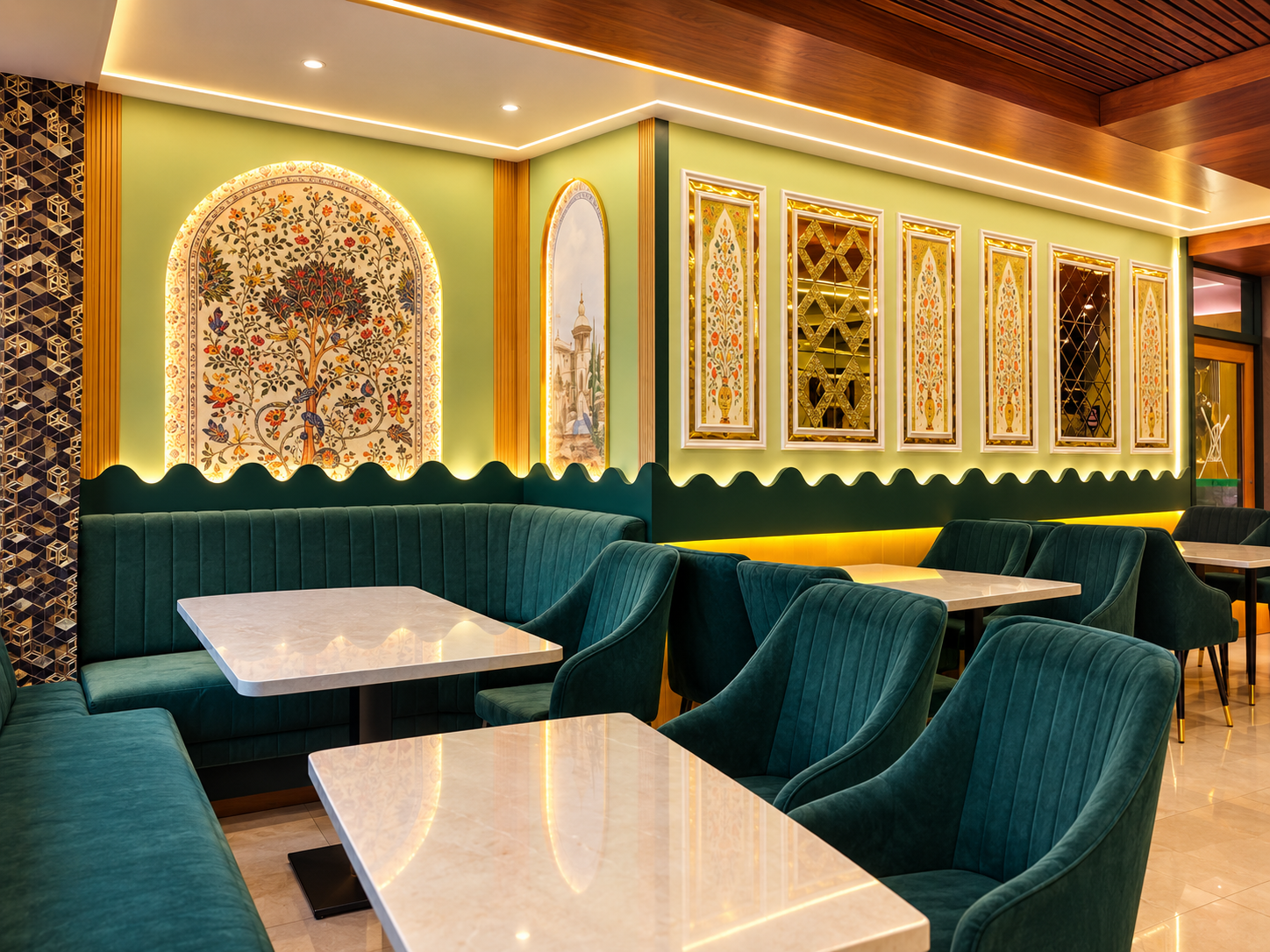 Haji Ali restaurant interior with elegant Mughlai-inspired décor, green velvet seating and warm golden lighting in Kolkata